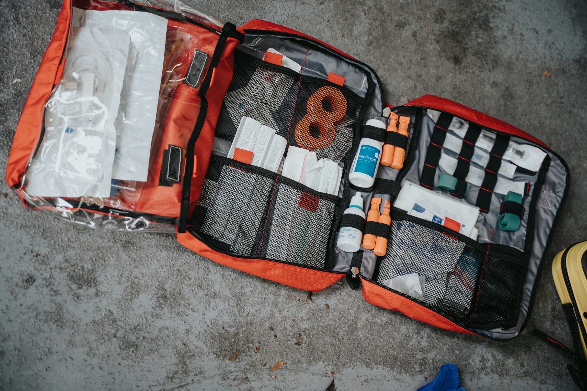 An open trauma kit laid out on the ground